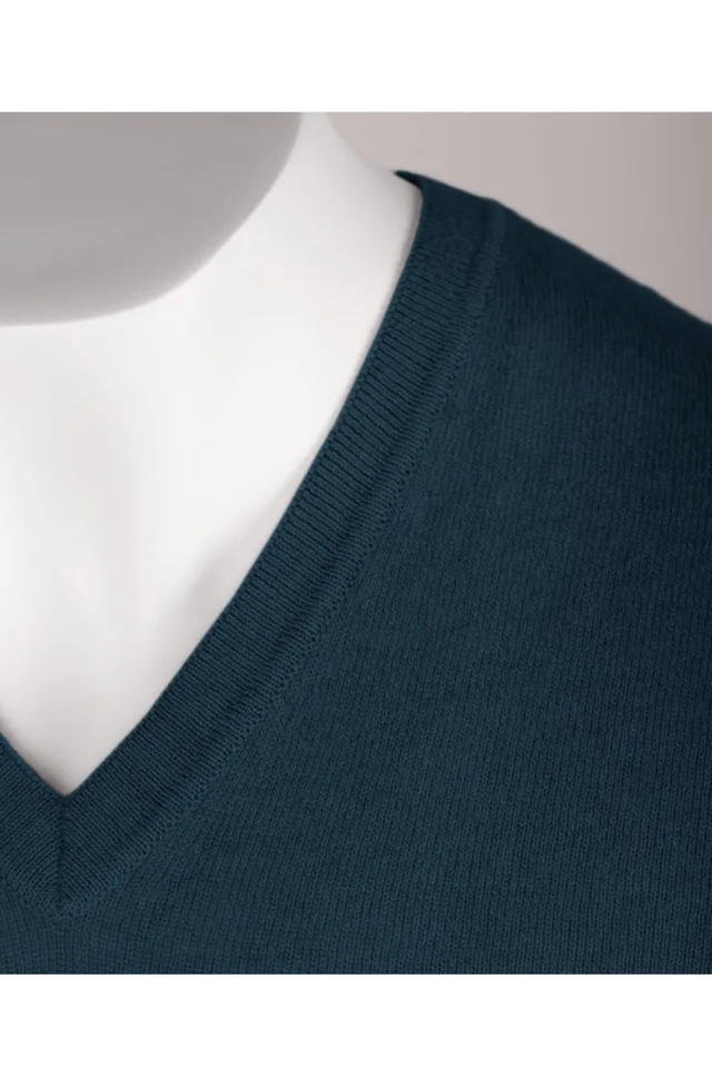 Close-up of the petrol blue cashmere V-neck and ribbed neckline.