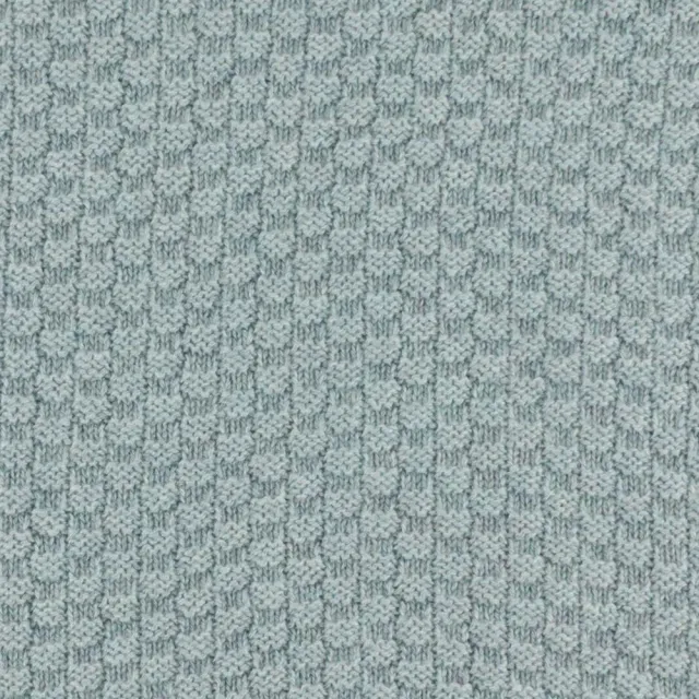 Close-up of the textured surface of grey cashmere moss stitch.