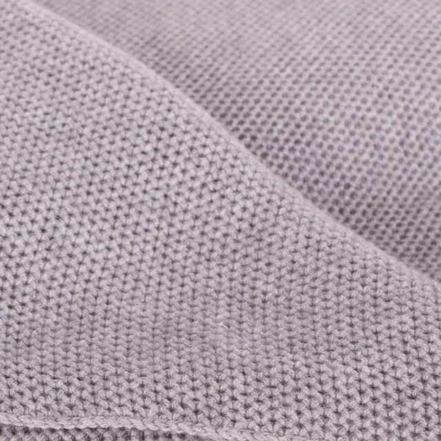 Close-up of the repeated waffle texture in a pale cashmere blanket.