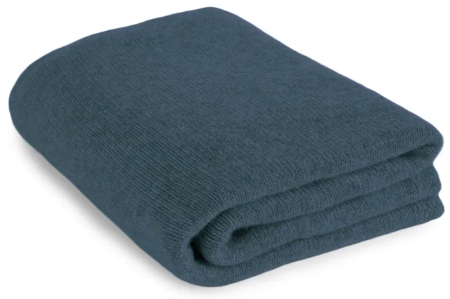 Teal blue cashmere travel blanket, neatly folded.