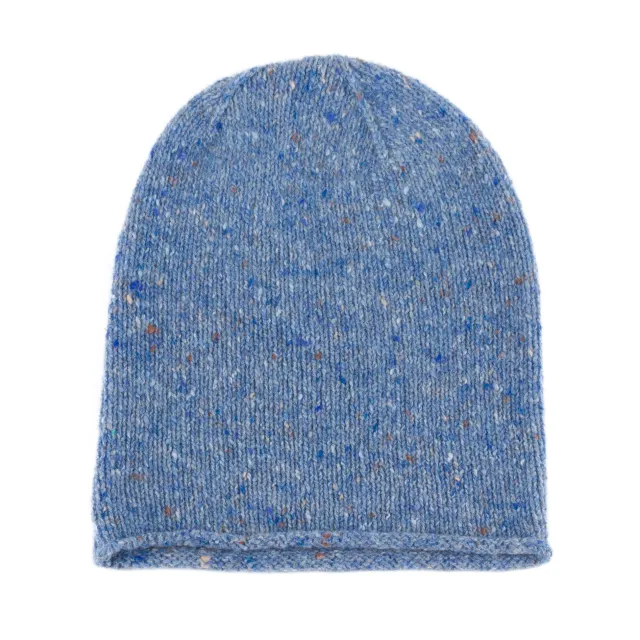 Denim blue beanie laid flat, with a rounded crown, rolled edge and small blue, cream and brown flecks.