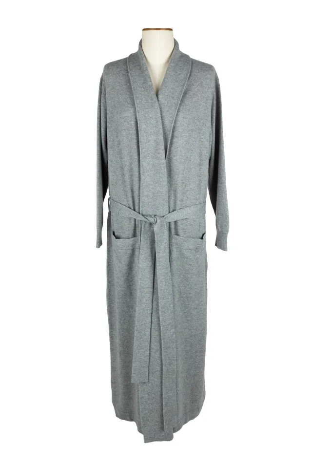 Long light grey dressing gown on a dress form, with a shawl collar, tied belt and two front pockets.