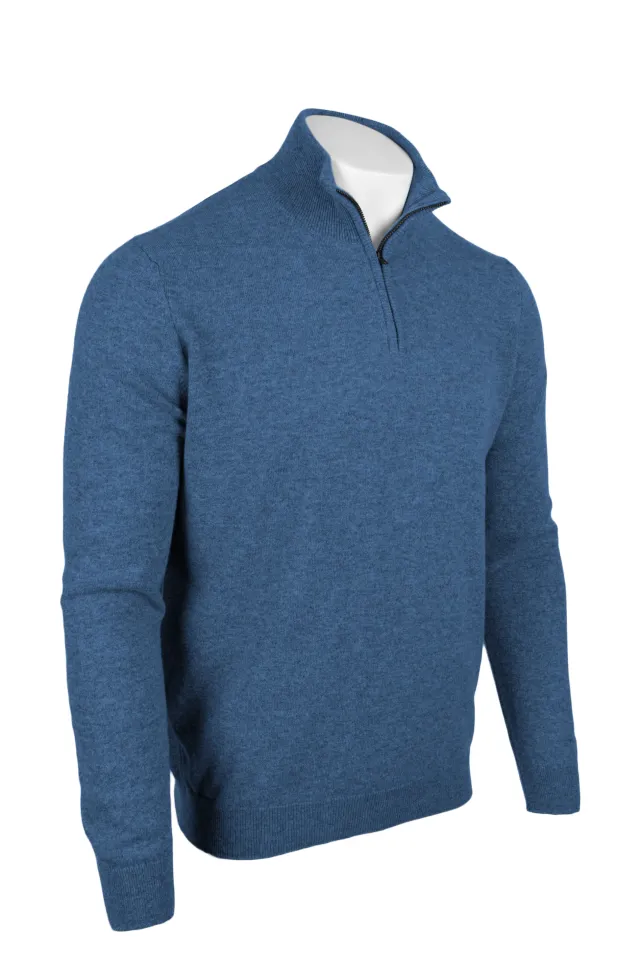 Denim blue quarter zip sweater shown at an angle, with a raised collar and ribbed cuffs and hem.