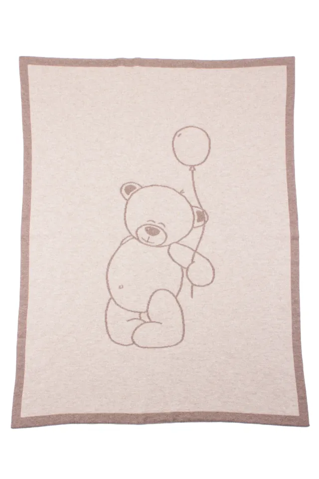 Cream and beige rectangular blanket with a brown border and an outlined teddy bear holding a balloon.